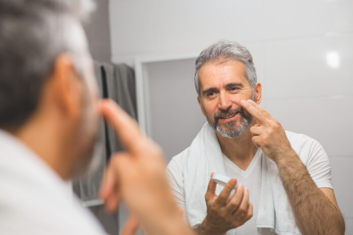 Smiling,Middle,Aged,Bearded,Man,Applying,Face,Cream